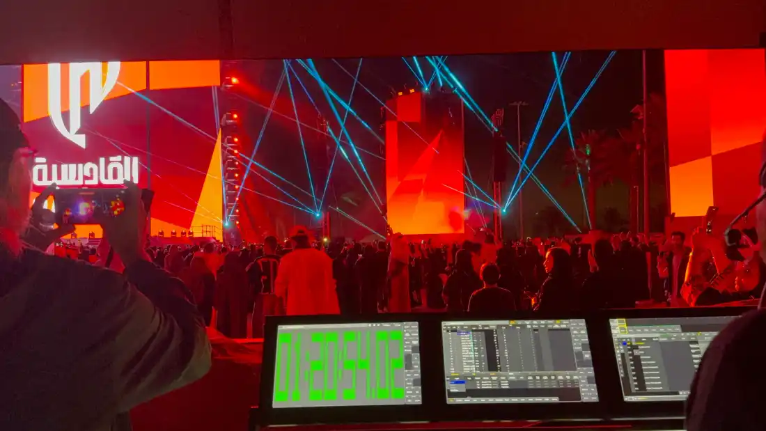 The laser show operator at the desk with timecode, the audience in front