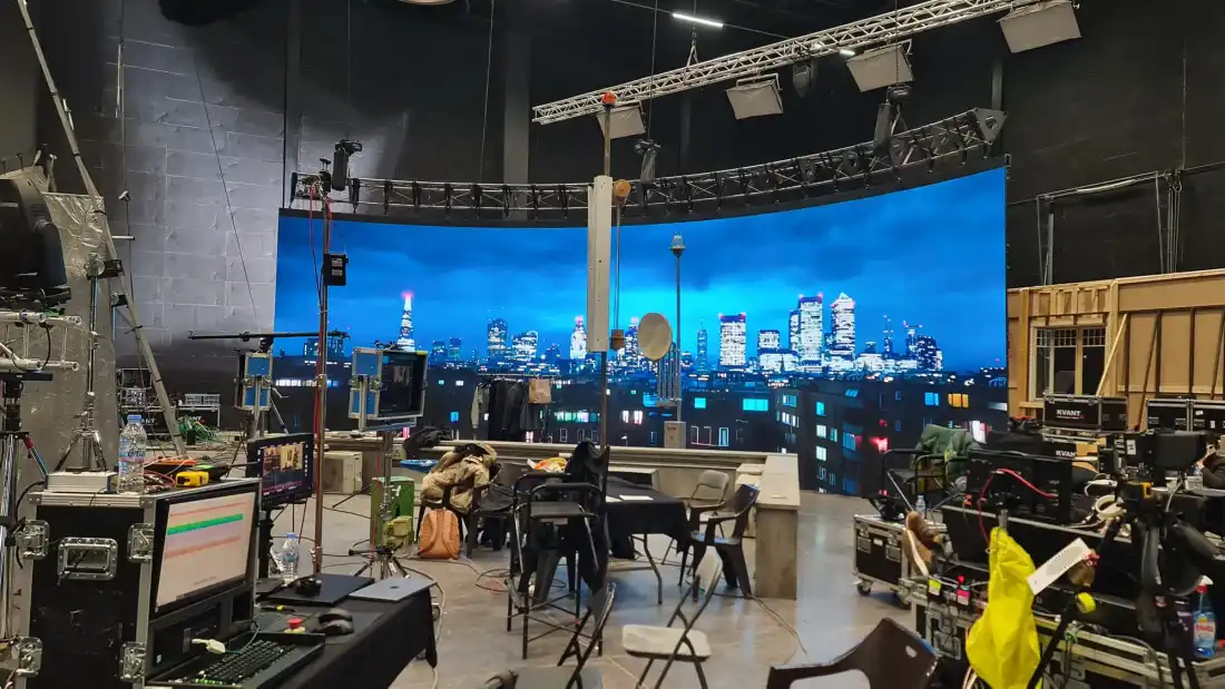 LED volume with a night city skyline for a television production
