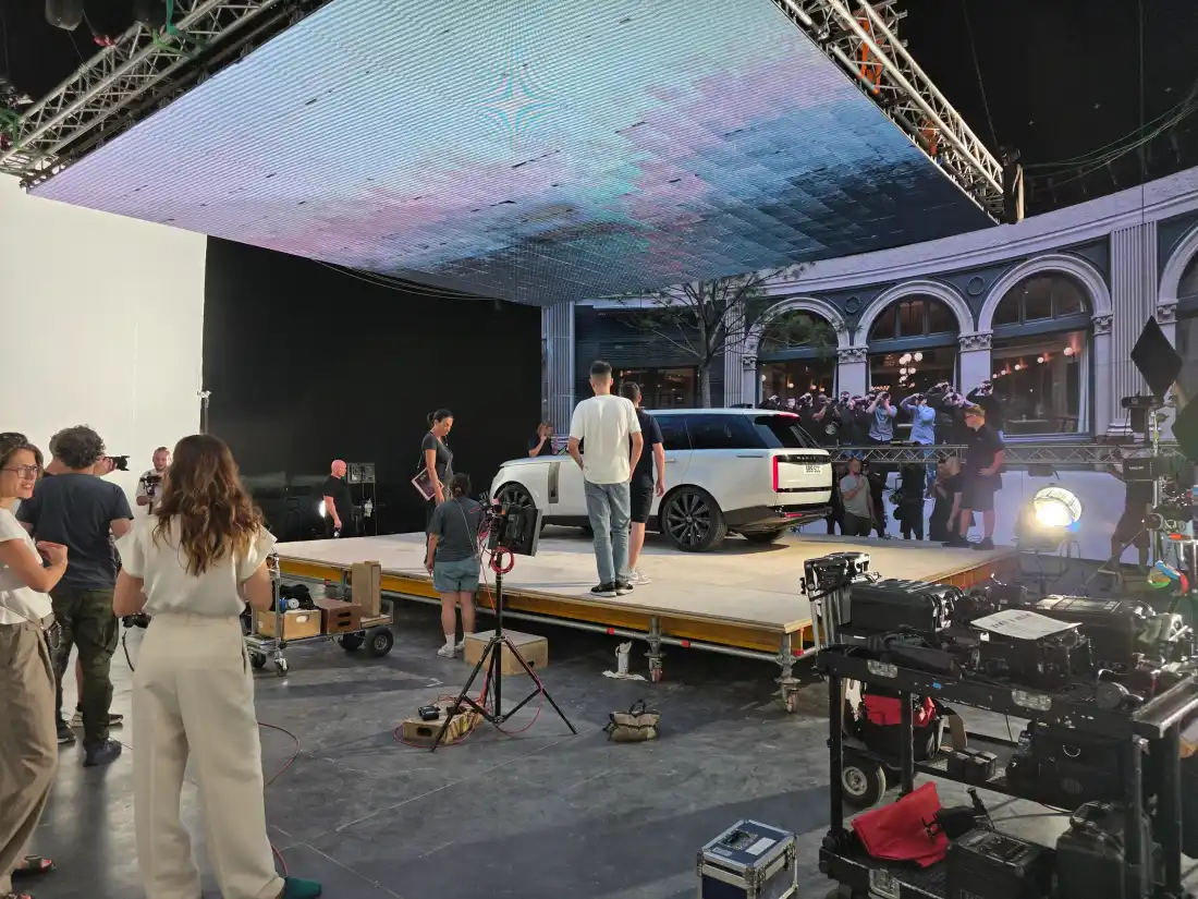 The production on set in front of the volume, with the Rome street scene on the wall