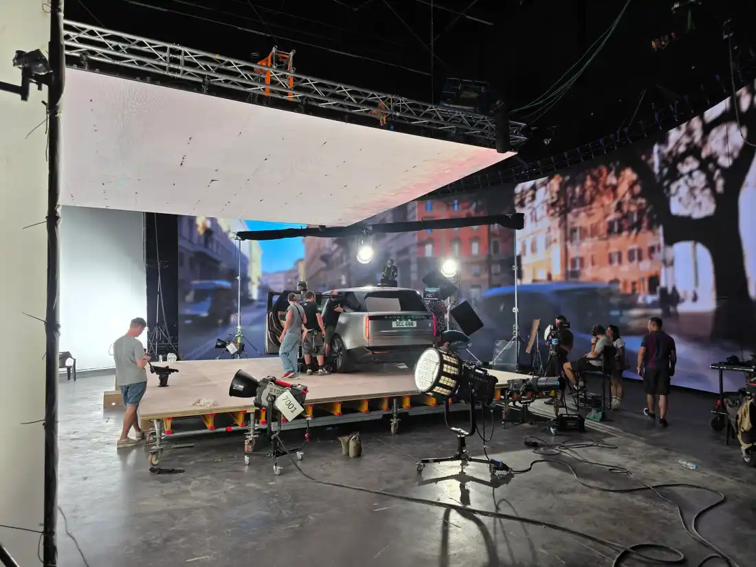 The LED volume from the side - the ceiling on rigging above the platform and the curved wall
