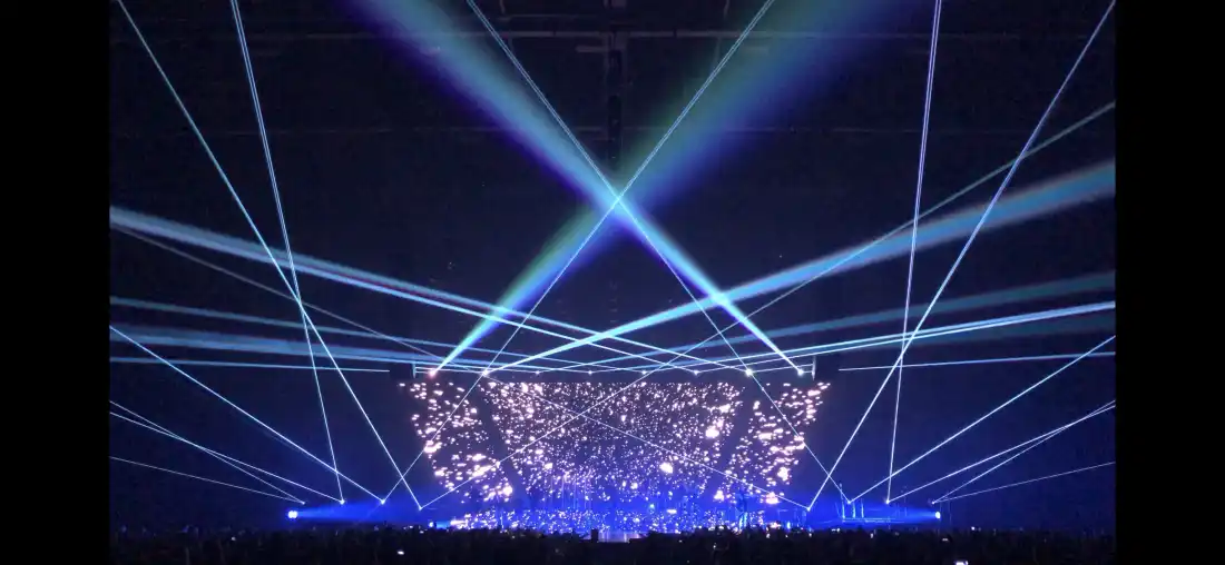 Laser beams across the whole arena and the LED stage behind the performer