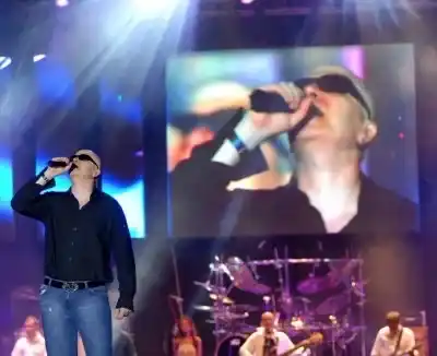 Slavi Trifonov singing on stage, behind him an LED screen showing a close-up and the Ku-Ku Band, archive photo