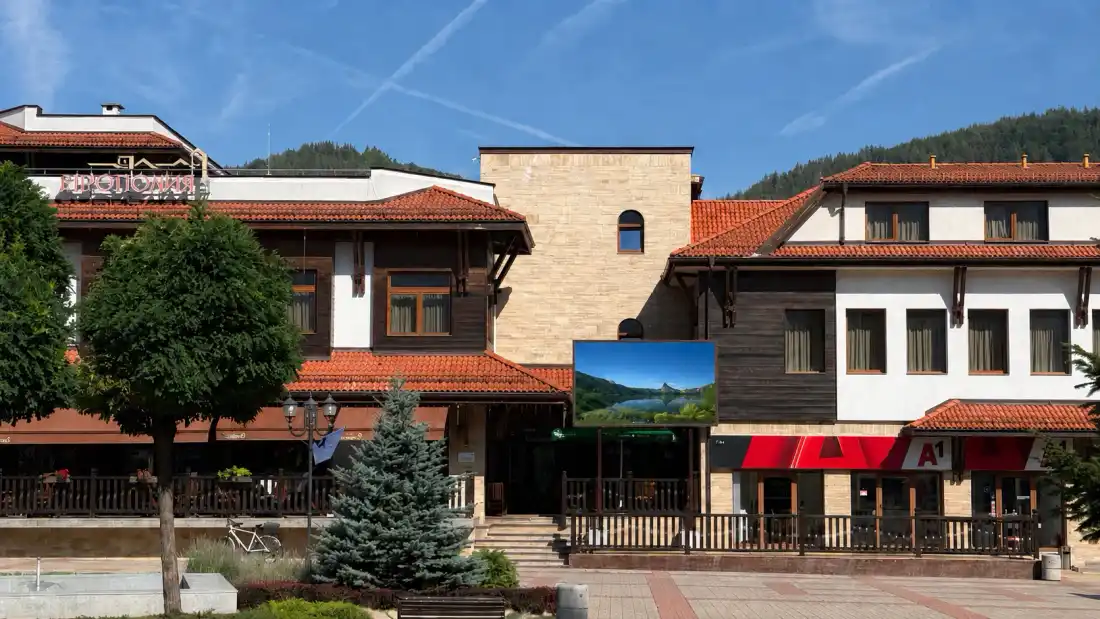 Outdoor LED screen on the facade of a hotel in Etropole in direct daylight