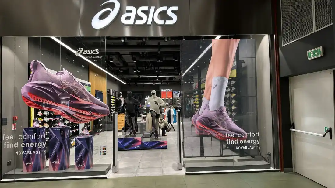 Transparent LED screen in the window of an Asics store